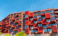 Newly built red multi-family apartment house seen in Berlin, Germany